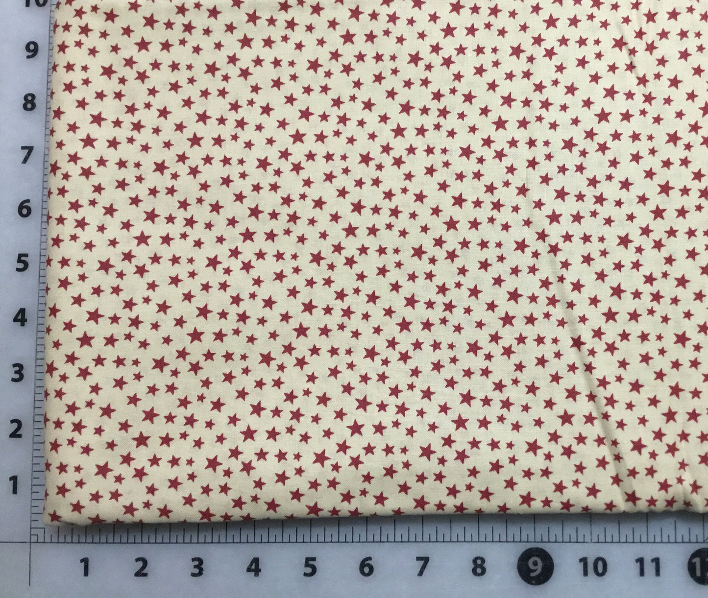 Small Red Stars on Cream background Patriotic Cotton Fabric from Checkers Fabrics